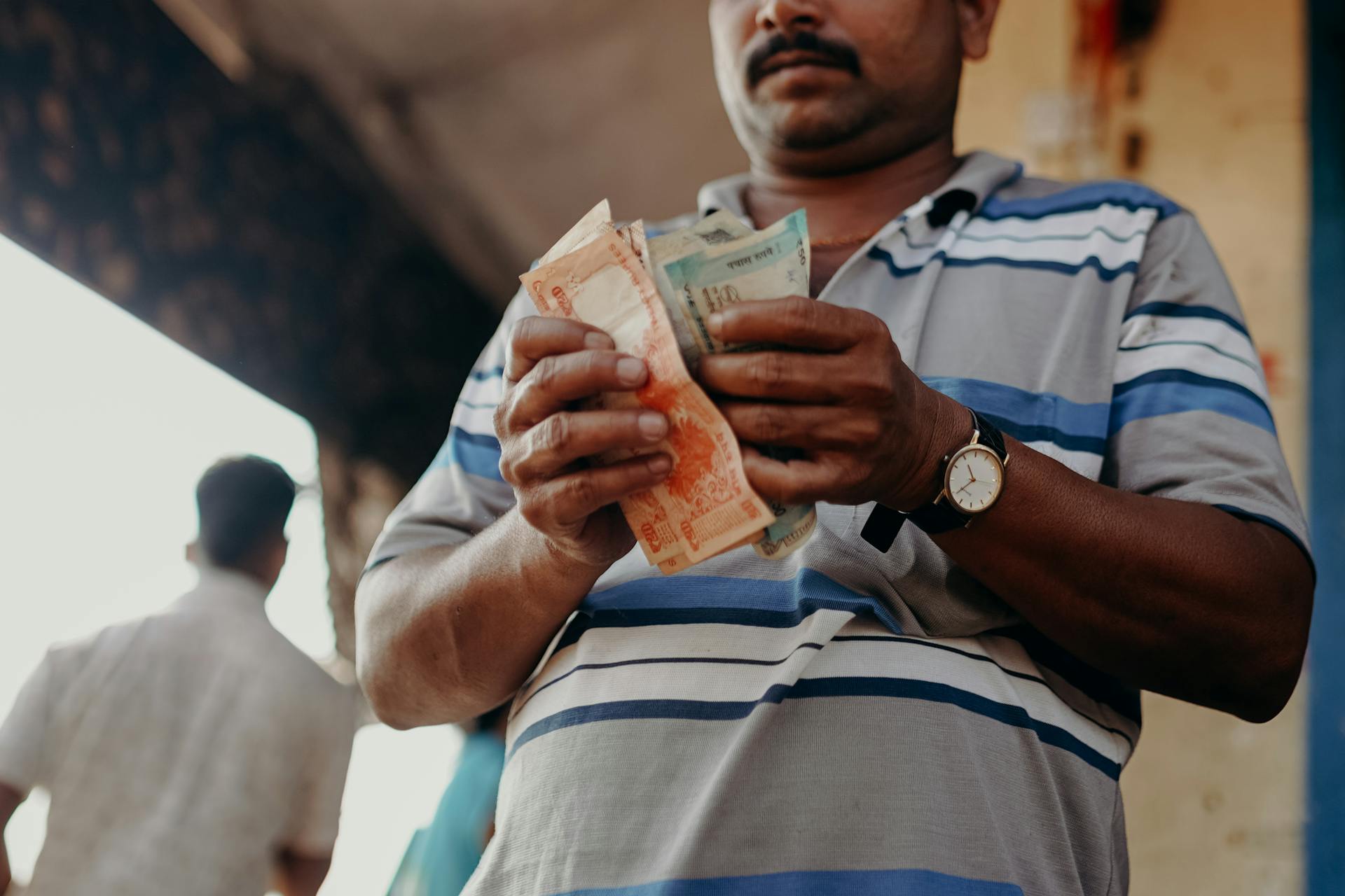 Photo by cottonbro studio: https://www.pexels.com/photo/man-in-blue-and-white-stripe-polo-shirt-holding-banknote-4427643/